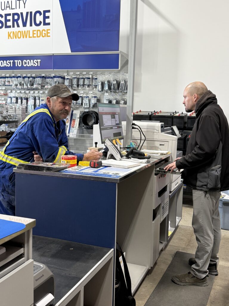 Peace Truck and Trailer. Located at 7002 - 98 Street, Unit 102 in Clairmont. This photo is of the branch manager helping a customer at Peace Truck and Trailer.